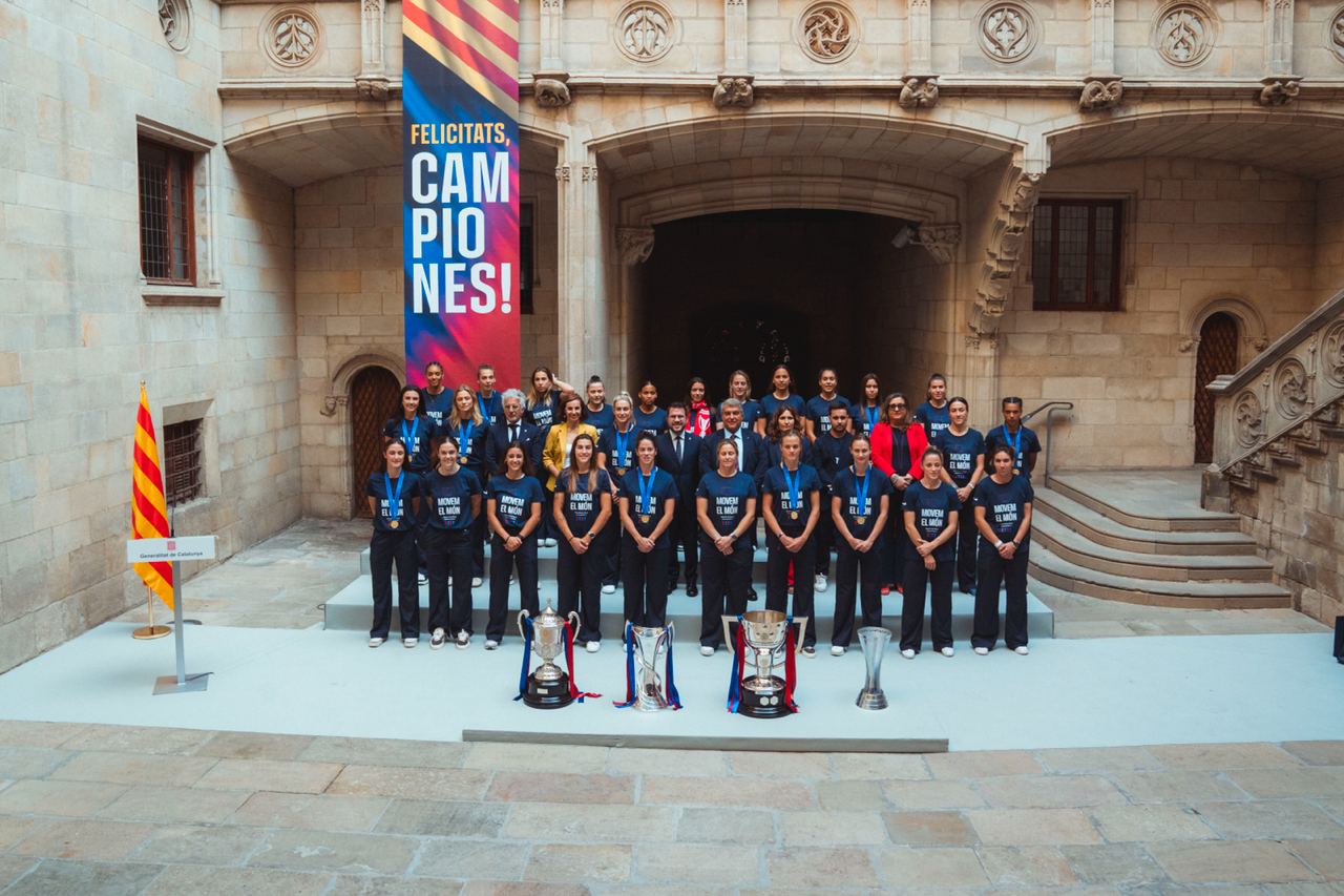 L'equip femení del FCB amb el president i les copes